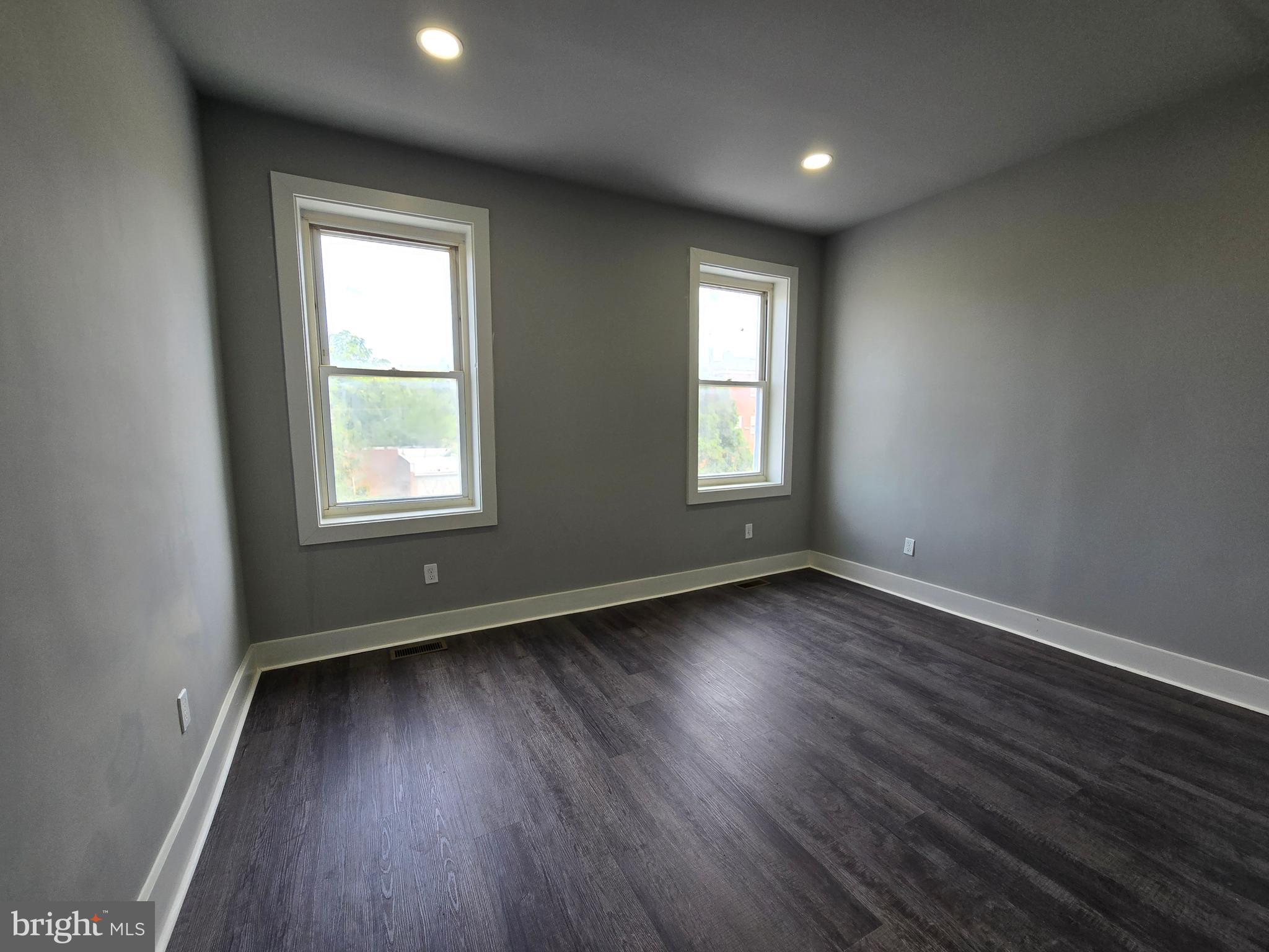 2811 East Preston Street Baltimore, MD 21213 - Photo 15 of 28 an empty room with wooden floor and windows