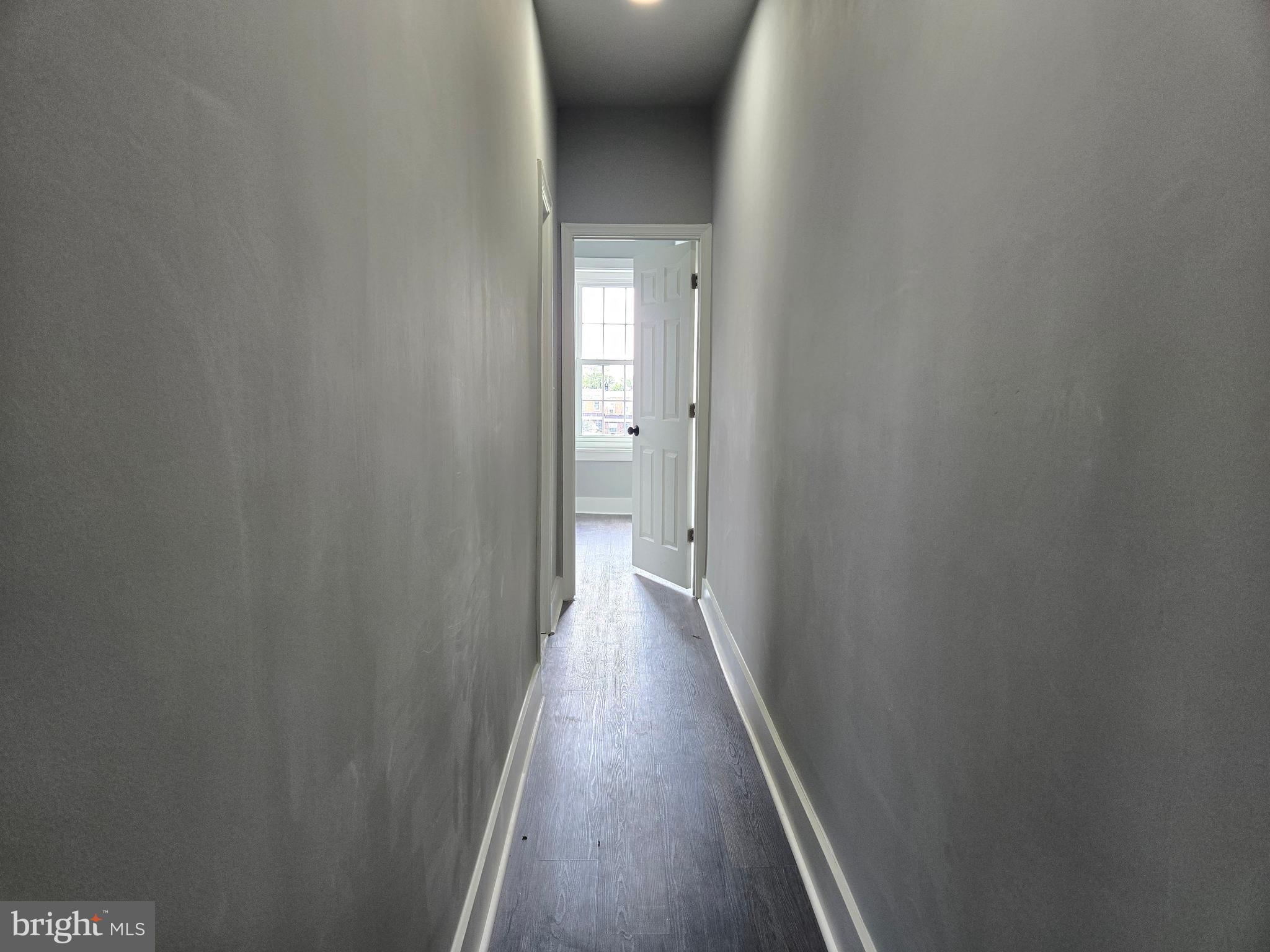 2811 East Preston Street Baltimore, MD 21213 - Photo 17 of 28 a view of a hallway with wooden floor