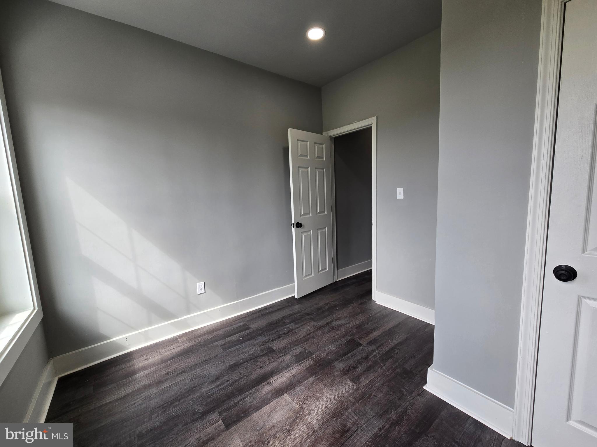 2811 East Preston Street Baltimore, MD 21213 - Photo 19 of 28 an empty room with wooden floor and entrance