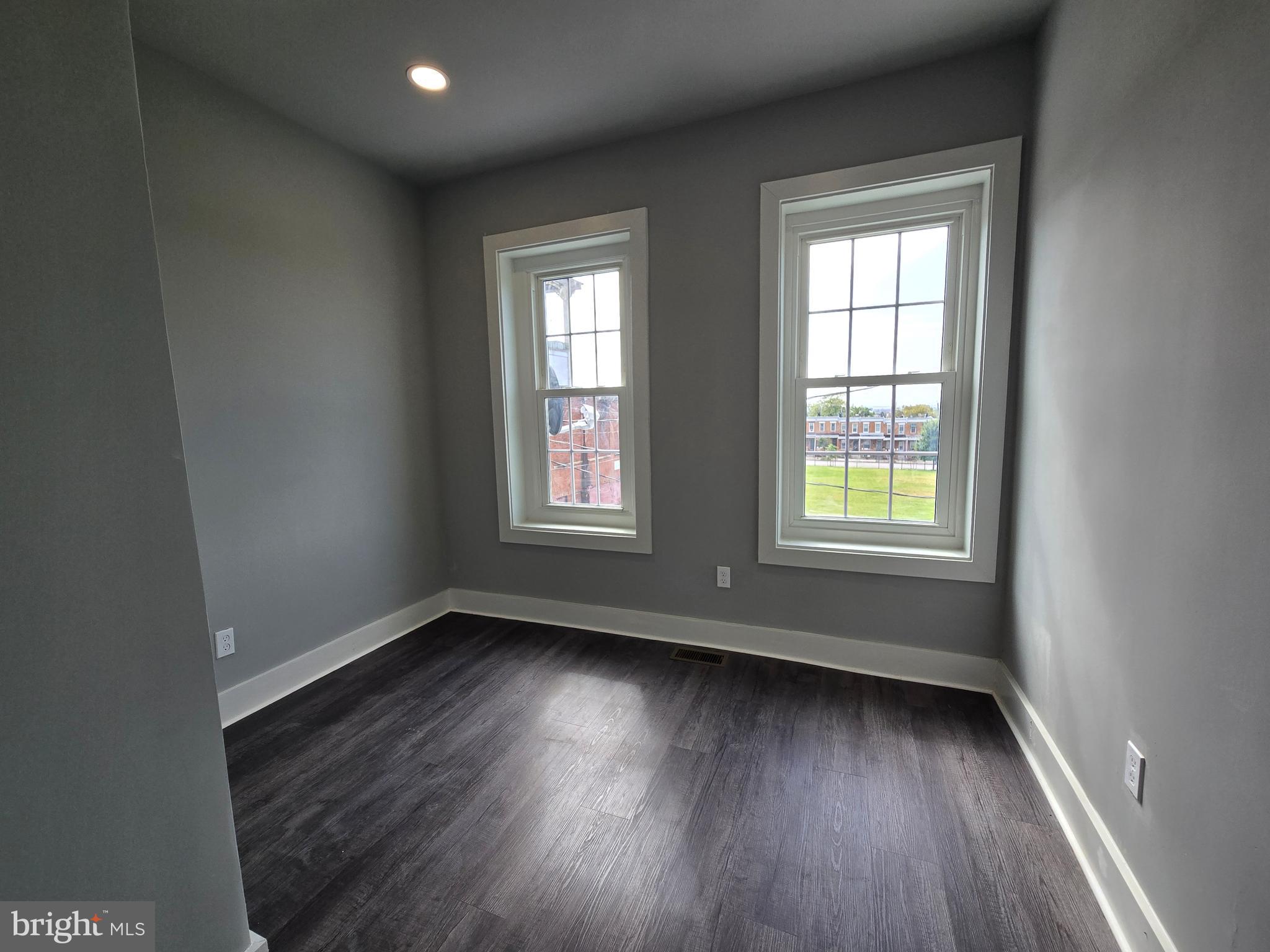 2811 East Preston Street Baltimore, MD 21213 - Photo 20 of 28 an empty room with wooden floor and windows