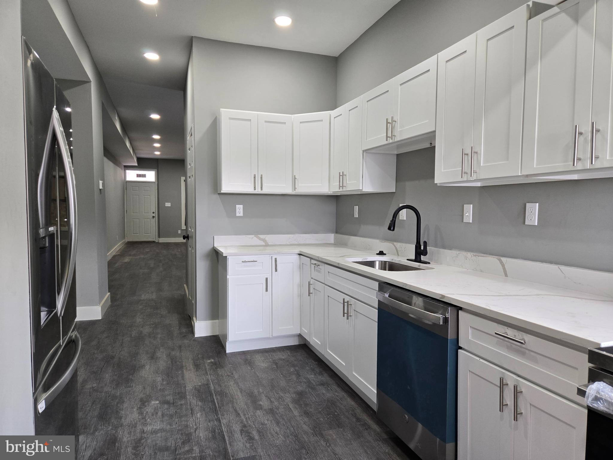 2811 East Preston Street Baltimore, MD 21213 - Photo 2 of 28 a kitchen with stainless steel appliances granite countertop a sink a stove and a refrigerator