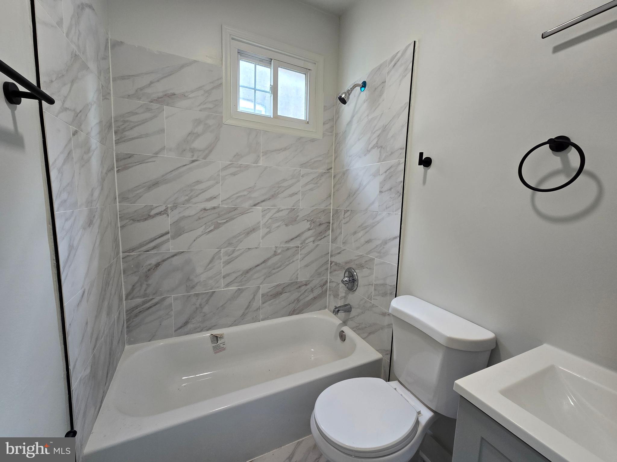 2811 East Preston Street Baltimore, MD 21213 - Photo 21 of 28 a bathroom with a toilet and a bath tub