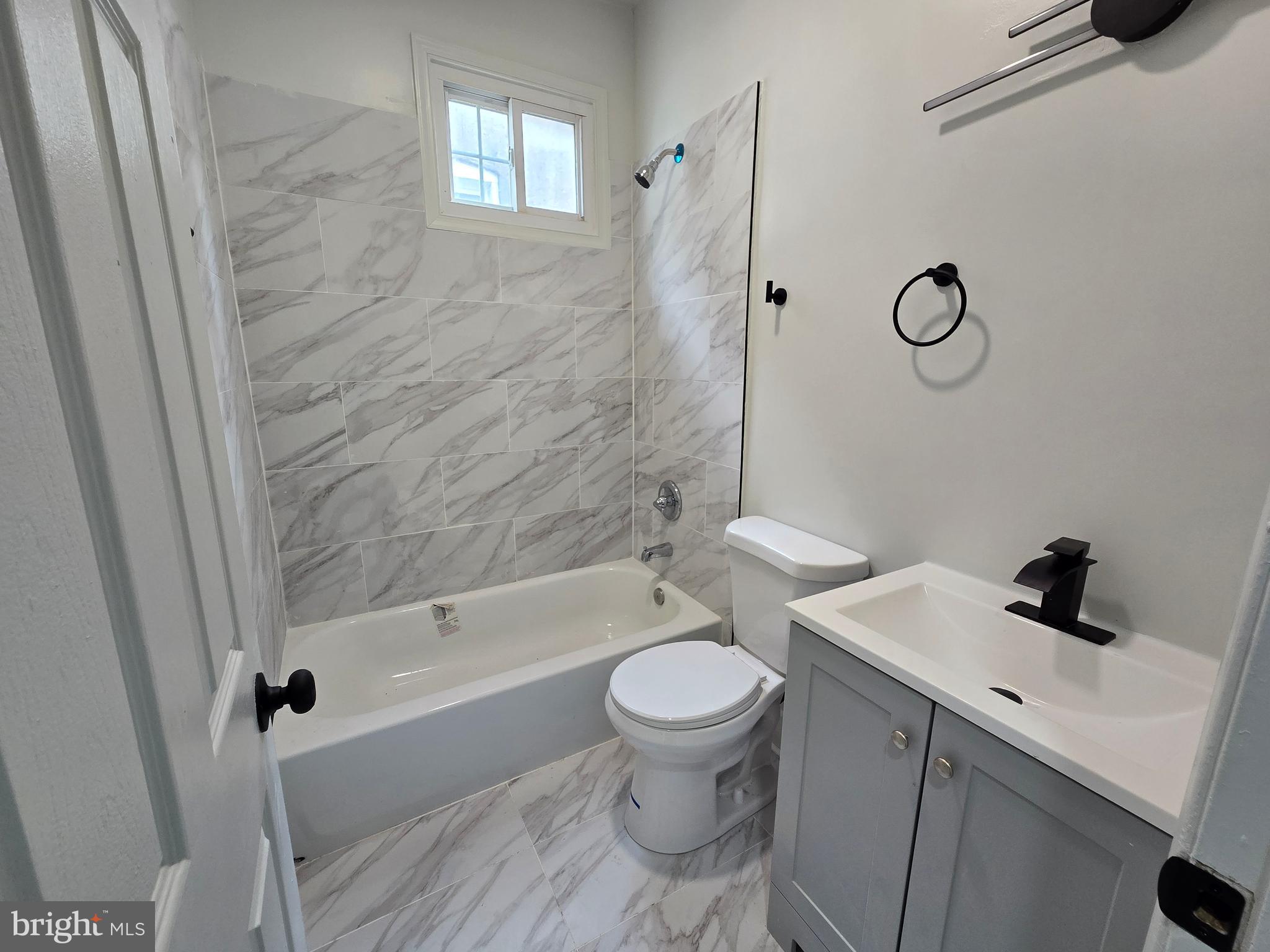 2811 East Preston Street Baltimore, MD 21213 - Photo 22 of 28 a bathroom with a sink toilet and shower