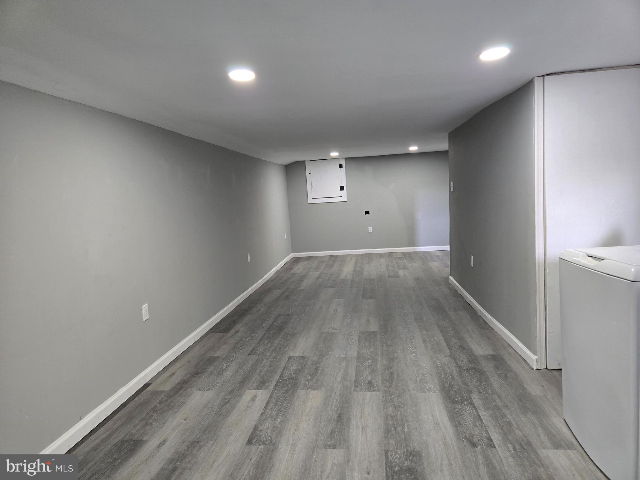 2811 East Preston Street Baltimore, MD 21213 - Photo 24 of 28 an empty room with wooden floor and windows