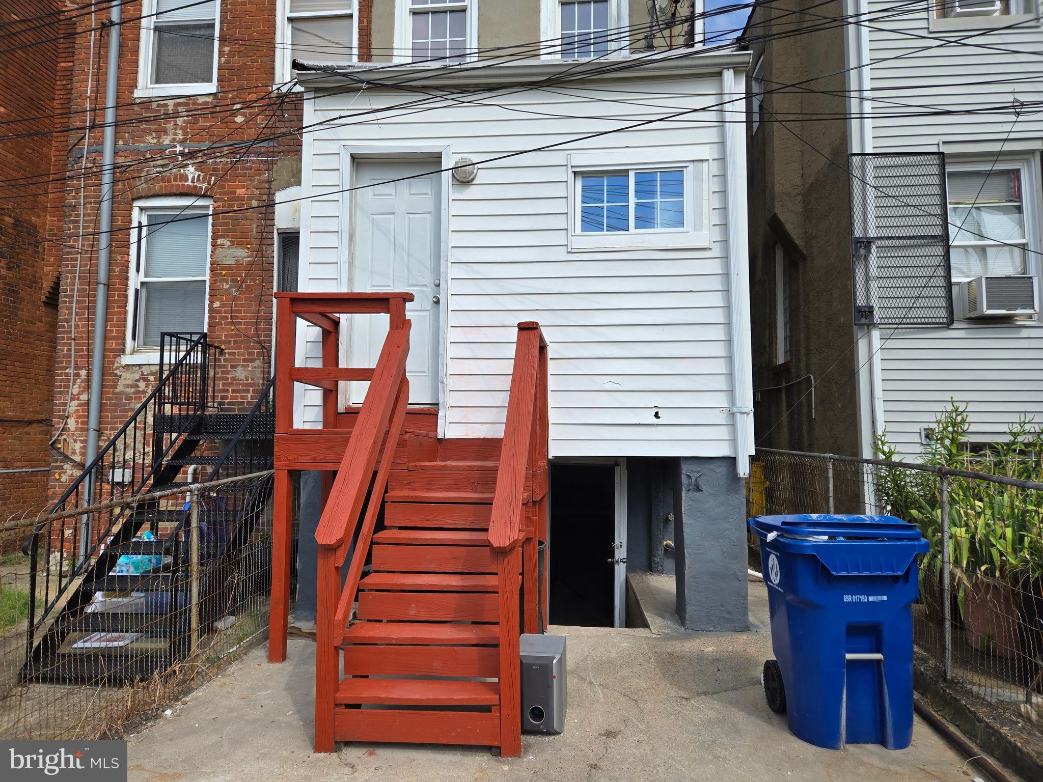 2811 East Preston Street Baltimore, MD 21213 - Photo 27 of 28 a front view of a house with wooden stairs and a large window