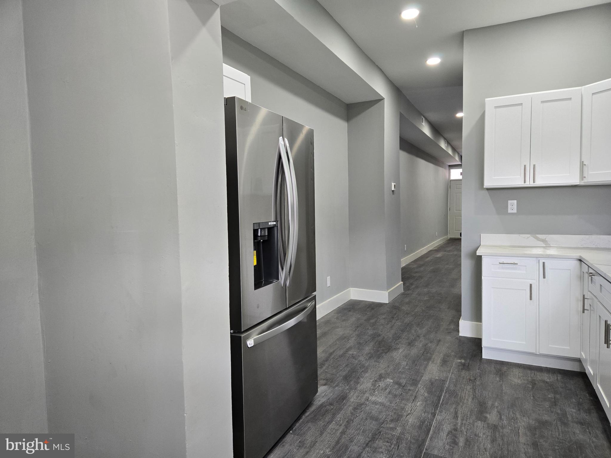 2811 East Preston Street Baltimore, MD 21213 - Photo 5 of 28 a view of a refrigerator in kitchen and white cabinets