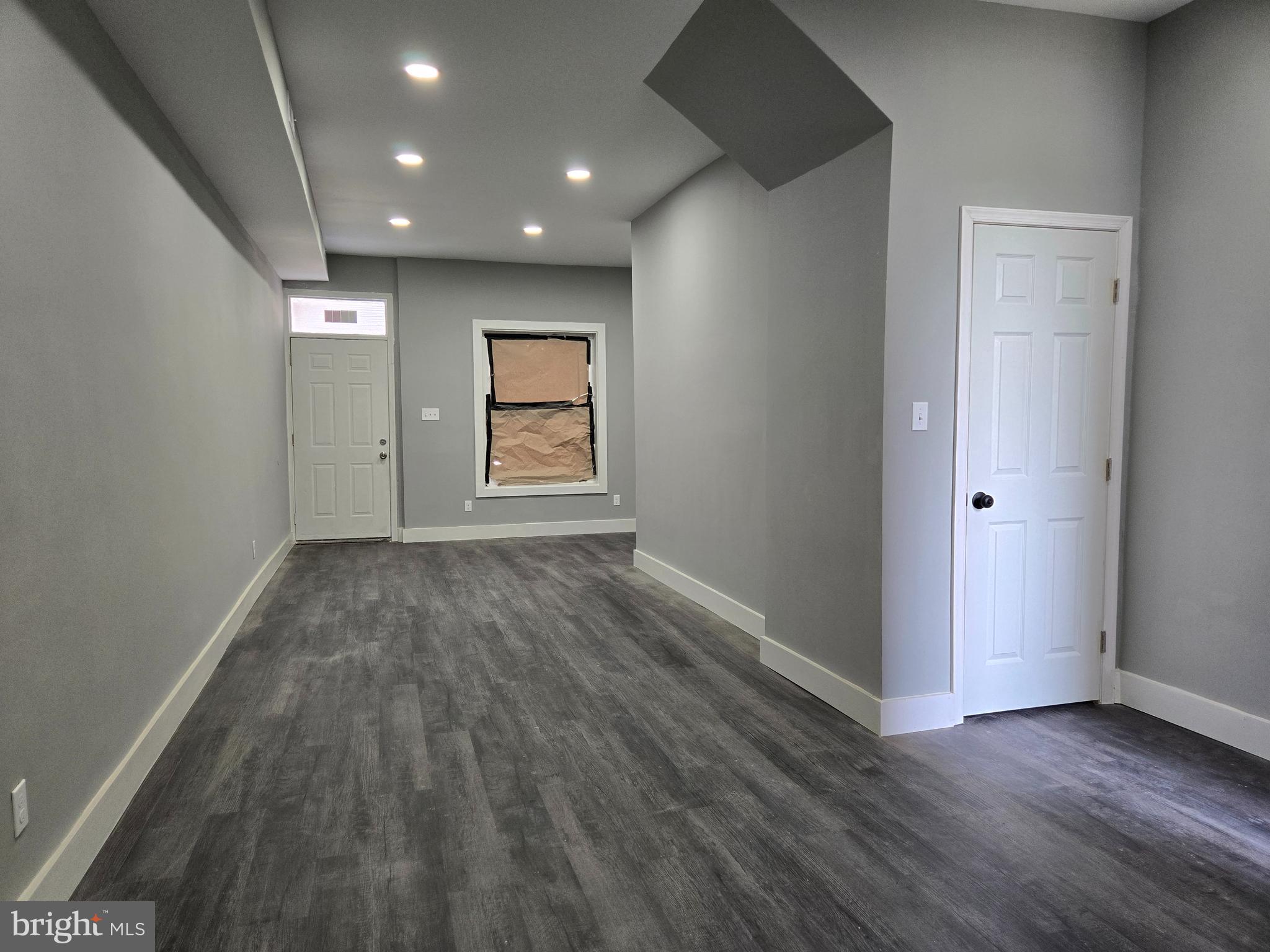 2811 East Preston Street Baltimore, MD 21213 - Photo 8 of 28 an empty room with wooden floor and windows