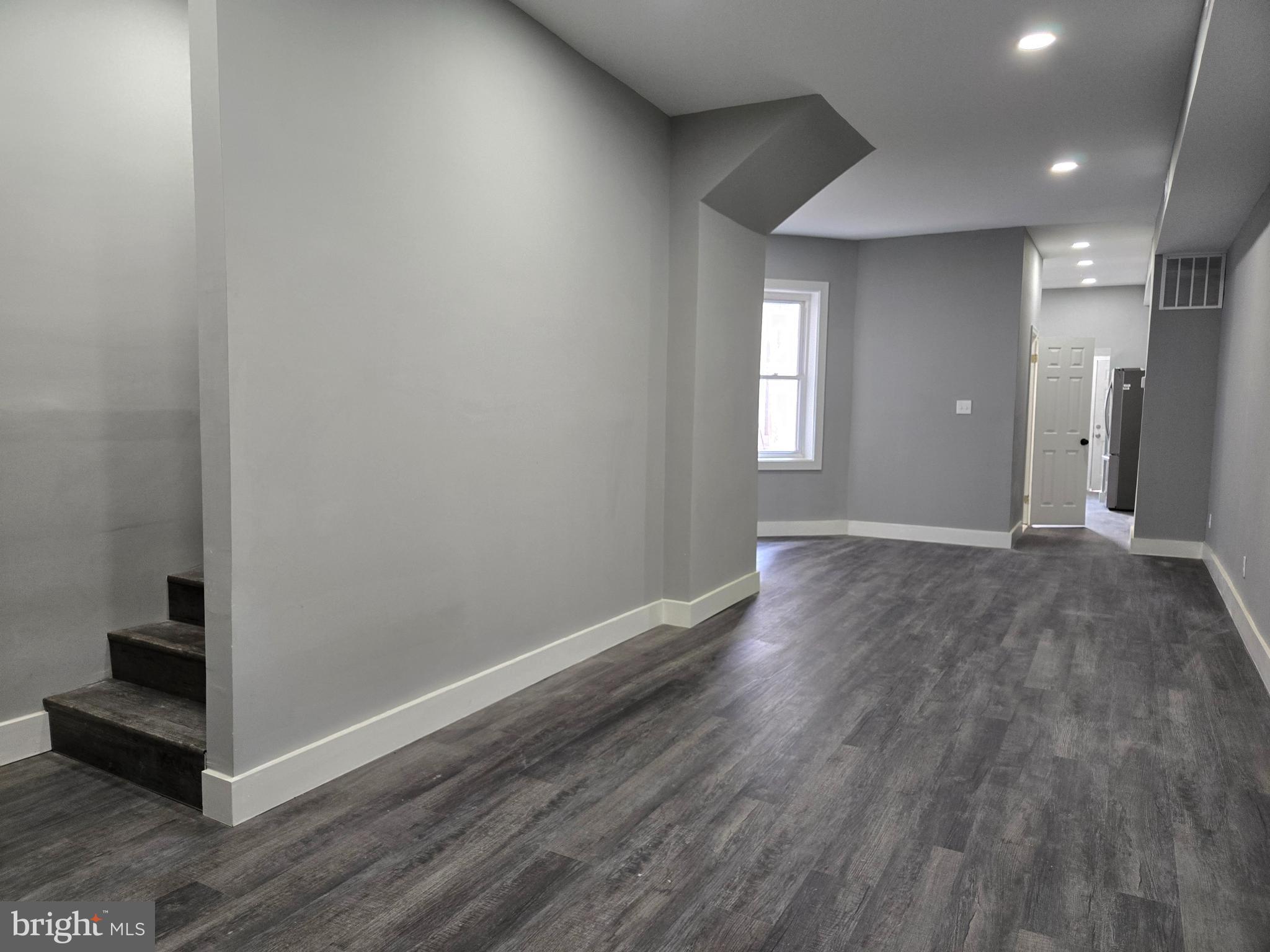 2811 East Preston Street Baltimore, MD 21213 - Photo 10 of 28 a view of wooden floor and windows in a room