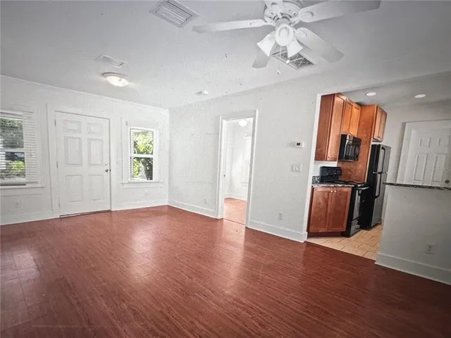 a kitchen with stainless steel appliances granite countertop a sink refrigerator and cabinets