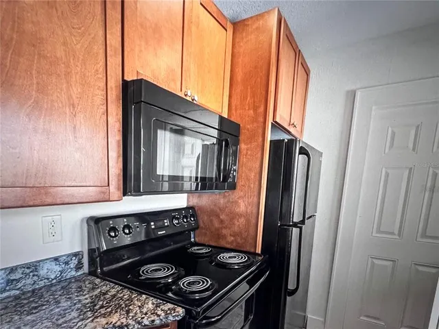 a bathroom with a granite countertop sink a window and a mirror