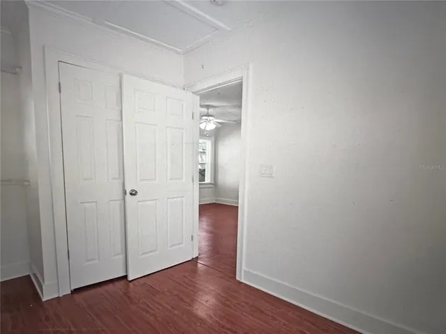 a view of a room with wooden floor and windows in it