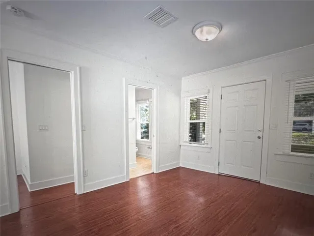 a view of a kitchen with wooden floor and a ceiling fan