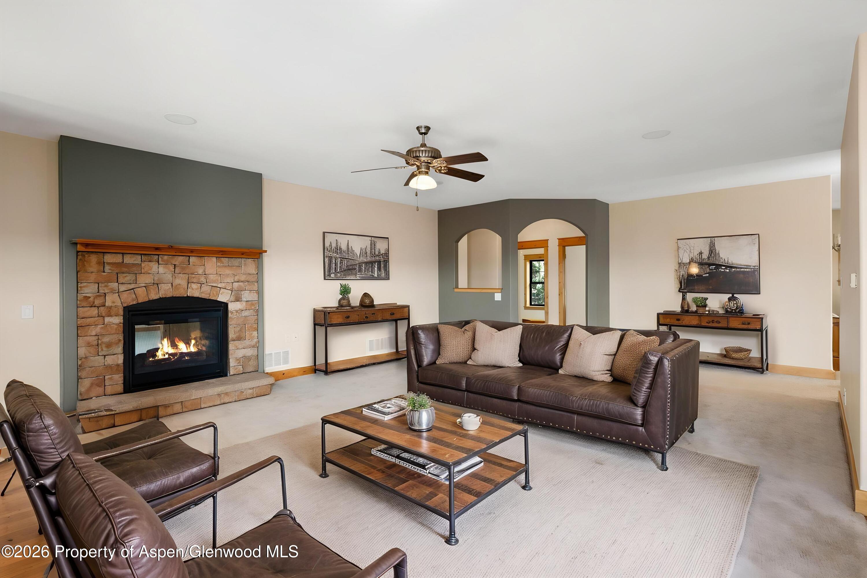 450 Summer Falls Road Silt, CO 81652 - Photo 5 of 50 a living room with couches a fireplace and a fireplace
