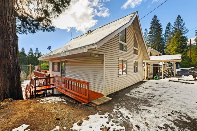 a view of house with a yard and sitting area