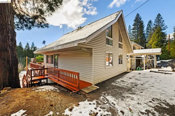 a view of house with a yard and sitting area