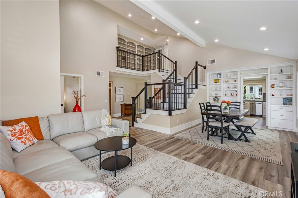 109 Cinnamon Ridge Road Brea, CA 92821 - Photo 1 of 67 Living room including vaulted ceiling, recessed lighting and view into dining room area including built ins at Kitchen entry and staircase leading to upstairs area.
