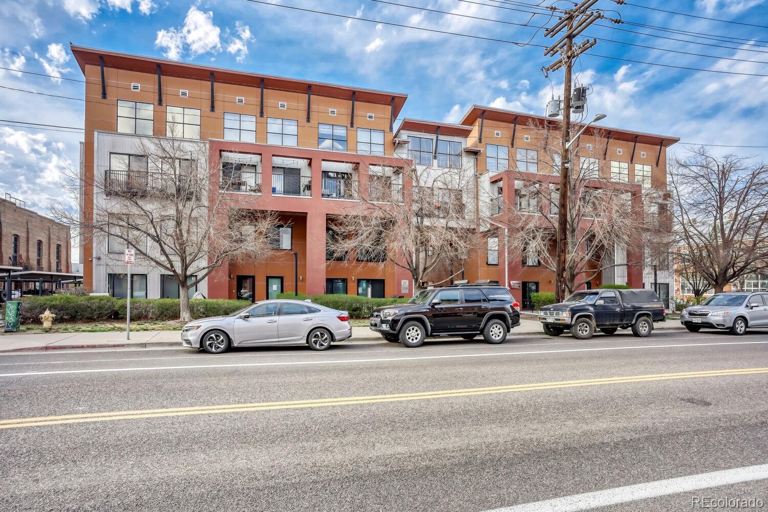 3295 Blake Street, Unit 202 Denver, CO 80205 - Photo 1 of 39 a car parked in front of a building