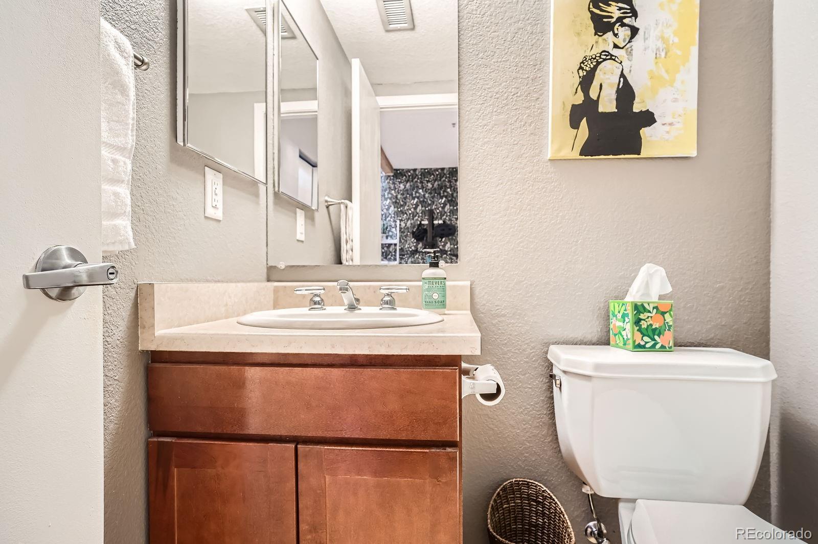 3295 Blake Street, Unit 202 Denver, CO 80205 - Photo 20 of 39 a bathroom with a sink mirror vanity and toilet