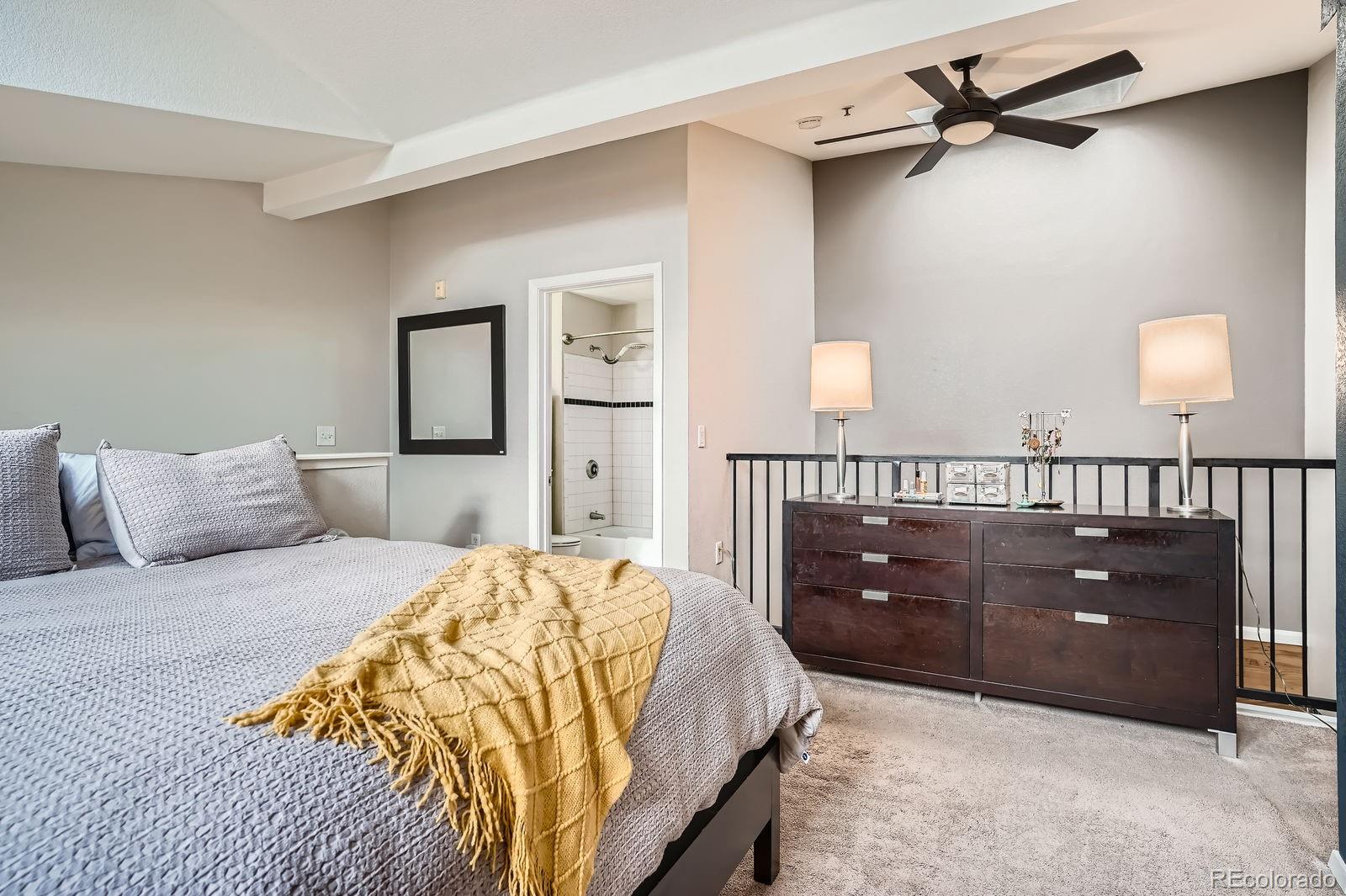 3295 Blake Street, Unit 202 Denver, CO 80205 - Photo 24 of 39 a bedroom with a bed and a dresser