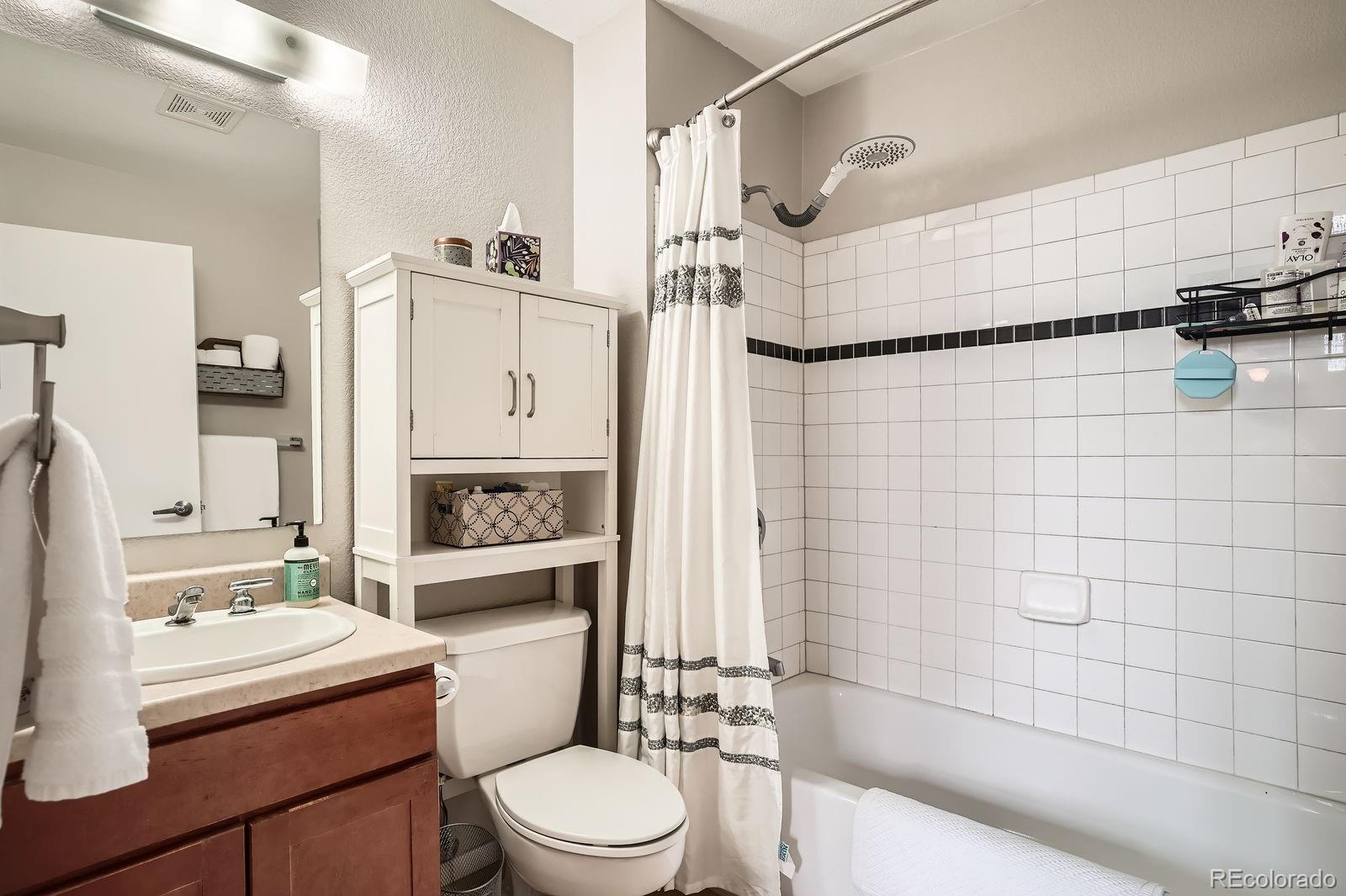 3295 Blake Street, Unit 202 Denver, CO 80205 - Photo 25 of 39 a bathroom with a sink toilet and shower