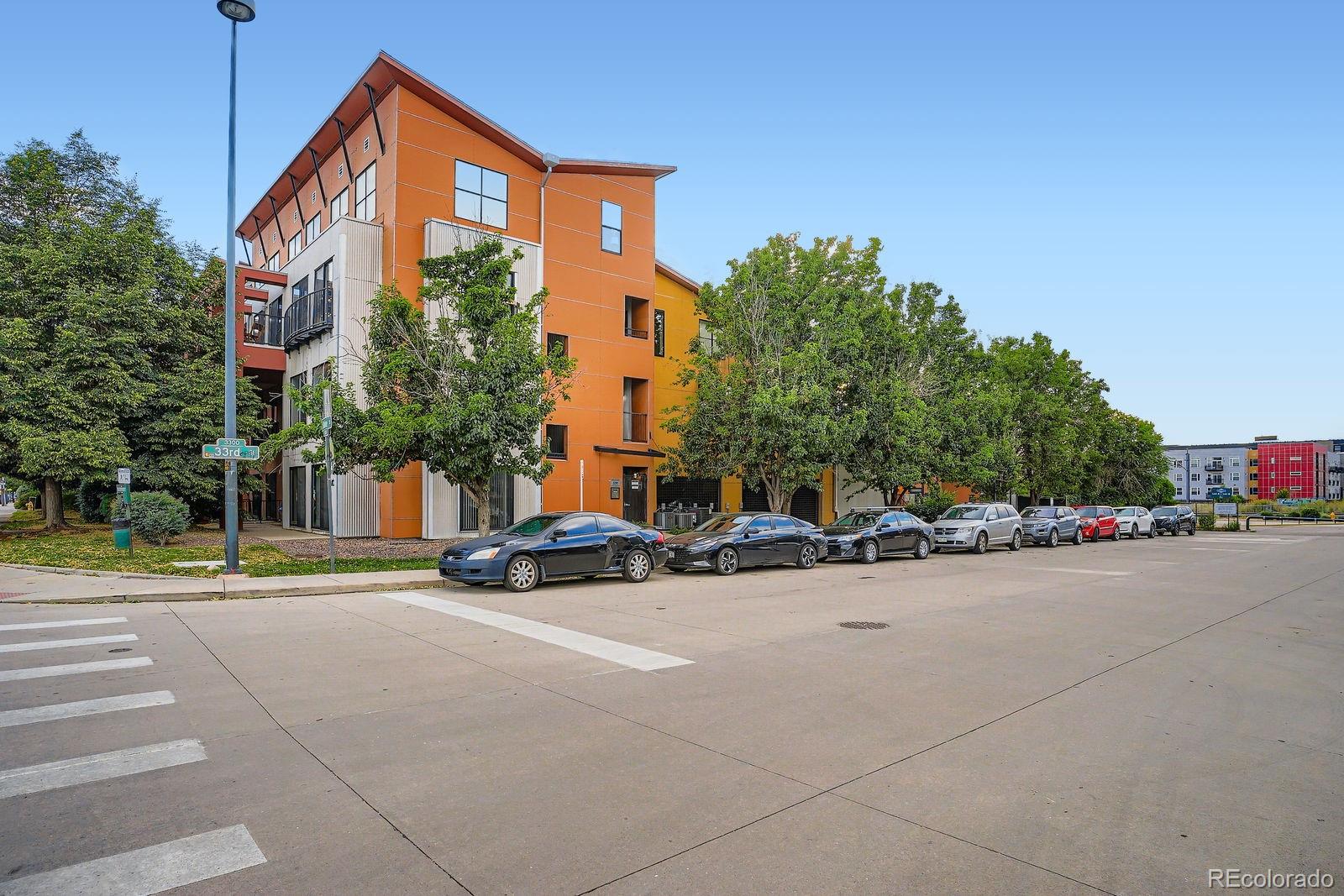 3295 Blake Street, Unit 202 Denver, CO 80205 - Photo 3 of 39 a view of a street with cars on road