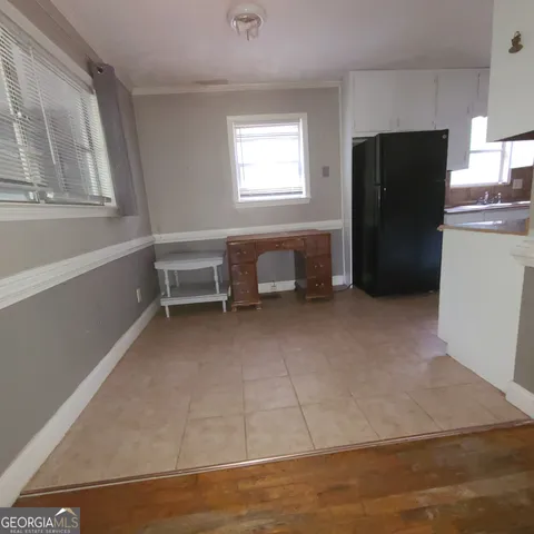 a view of a kitchen with refrigerator and window