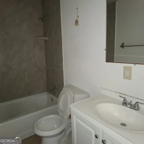 a bathroom with a toilet a sink and bathtub