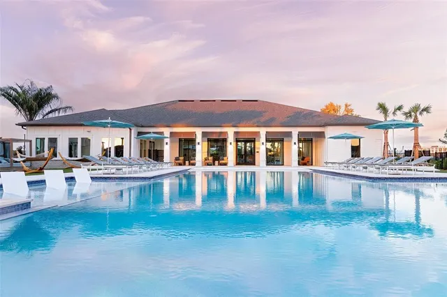 a front view of a house with swimming pool having outdoor seating