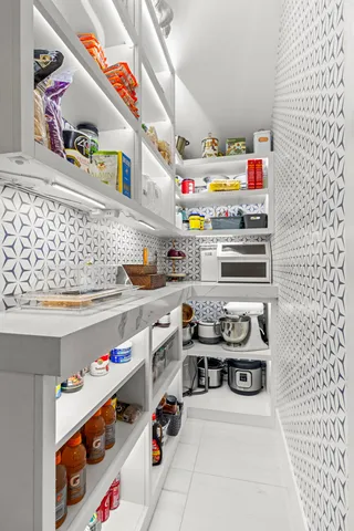 a kitchen with counter space appliances and furniture