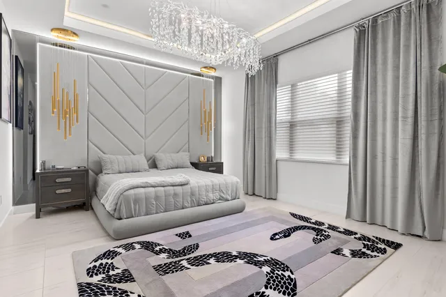 a view of a dining room with furniture and a chandelier