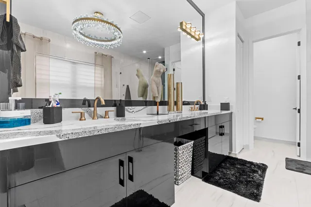 a bathroom with a granite countertop toilet a sink and a bathtub