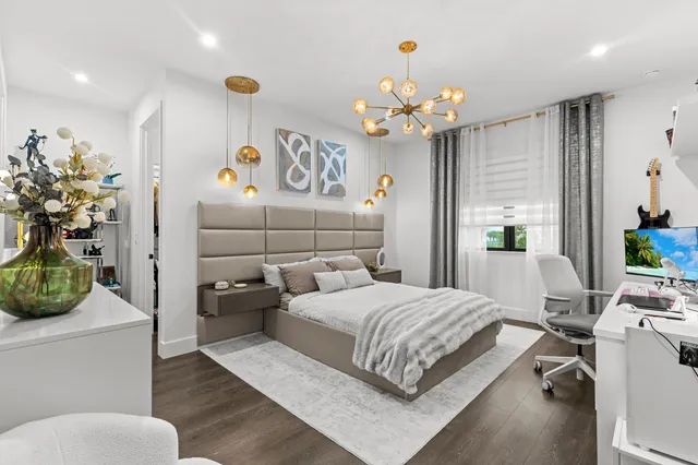 a view of swimming pool with seating space and trees in the background