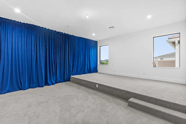 a view of a backyard with swimming pool and sitting area