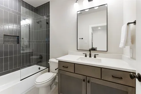 a spacious bedroom with a bed and a flat screen tv