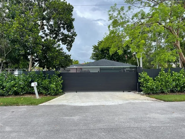 a view of backyard with plants and trees