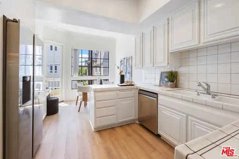 a kitchen with cabinets oven and a wooden floor