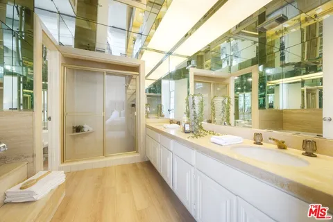 a spacious bathroom with a granite countertop sink and a mirror
