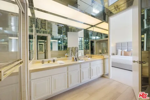 a bathroom with a double vanity sink and mirror