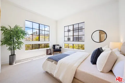 a bedroom with bed and a window