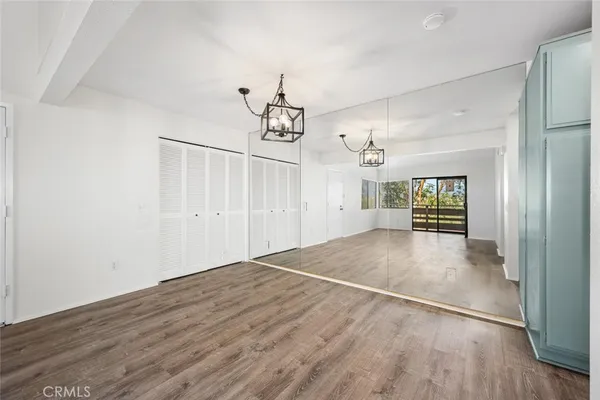 a view of a dining room with furniture wooden floor and a chandelier
