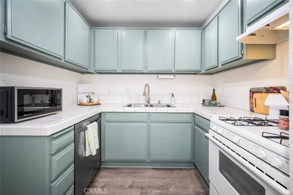a kitchen with stainless steel appliances granite countertop a sink stove and cabinets
