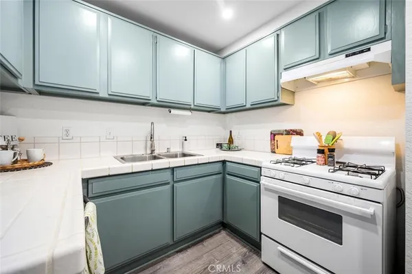a kitchen with a sink cabinets and appliances