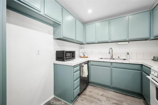 a white stove top oven sitting inside of a kitchen