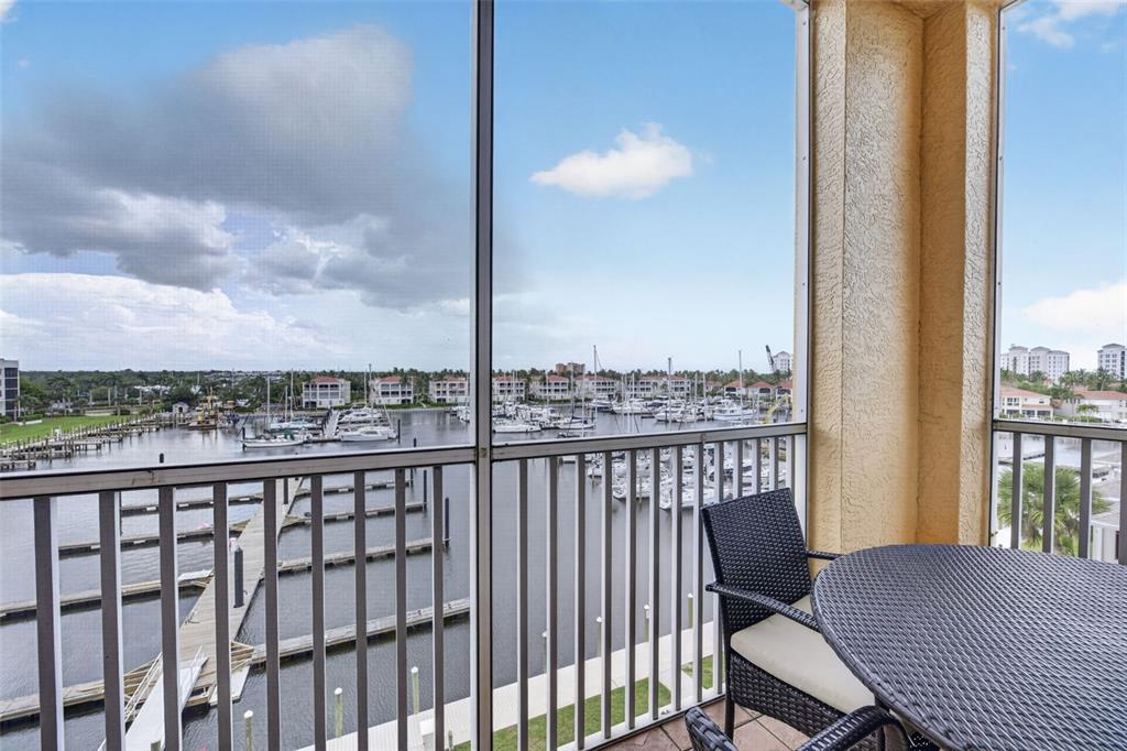 2060 Matecumbe Key Road, Unit 2506 Punta Gorda, FL 33955 - Photo 29 of 38 a view of a balcony with table and chairs