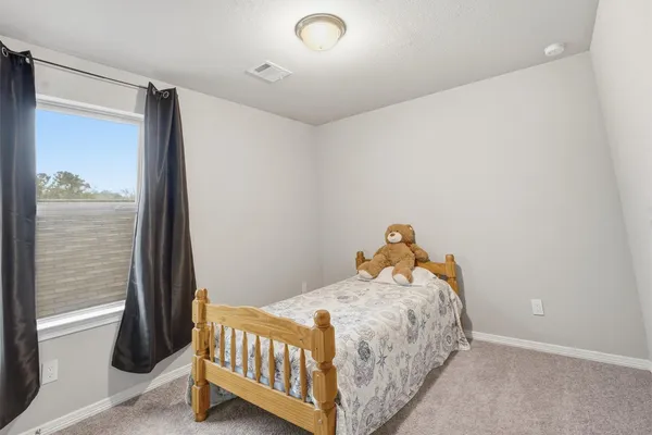 a bedroom with a bed and a window