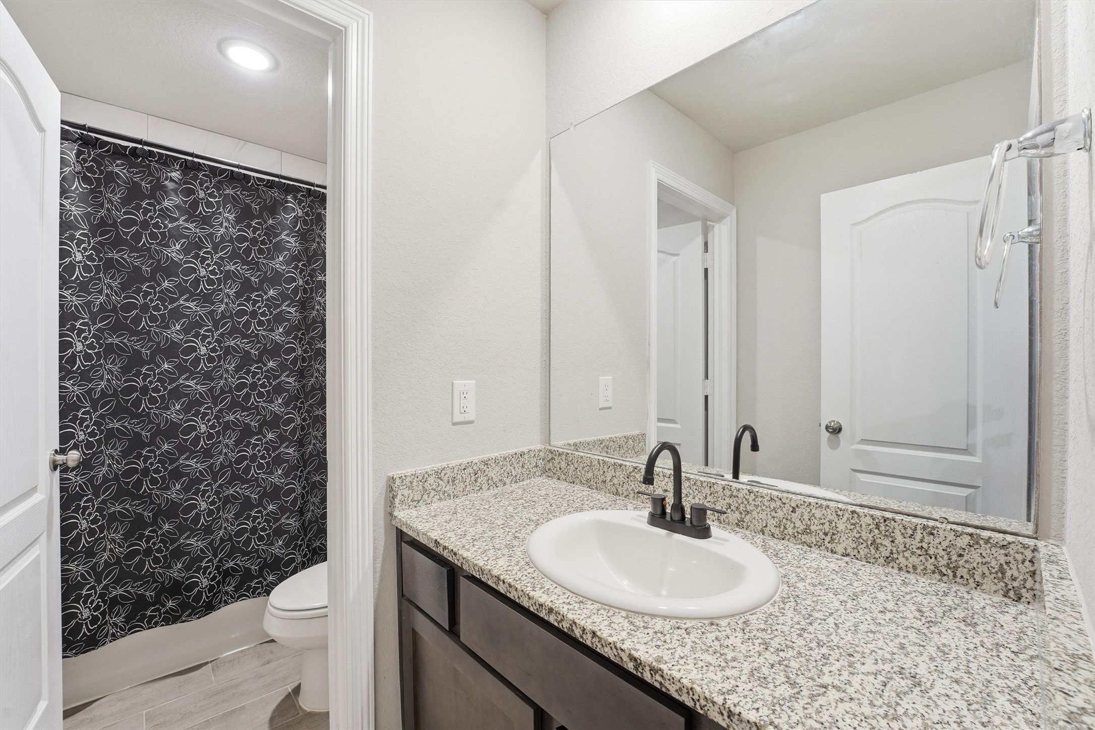 24818 Russet Bluff Trail Houston, TX 77336 - Photo 16 of 23 a bathroom with a granite countertop sink and a mirror