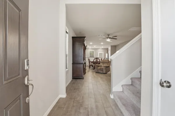 a view of a hallway with furniture and a livingroom