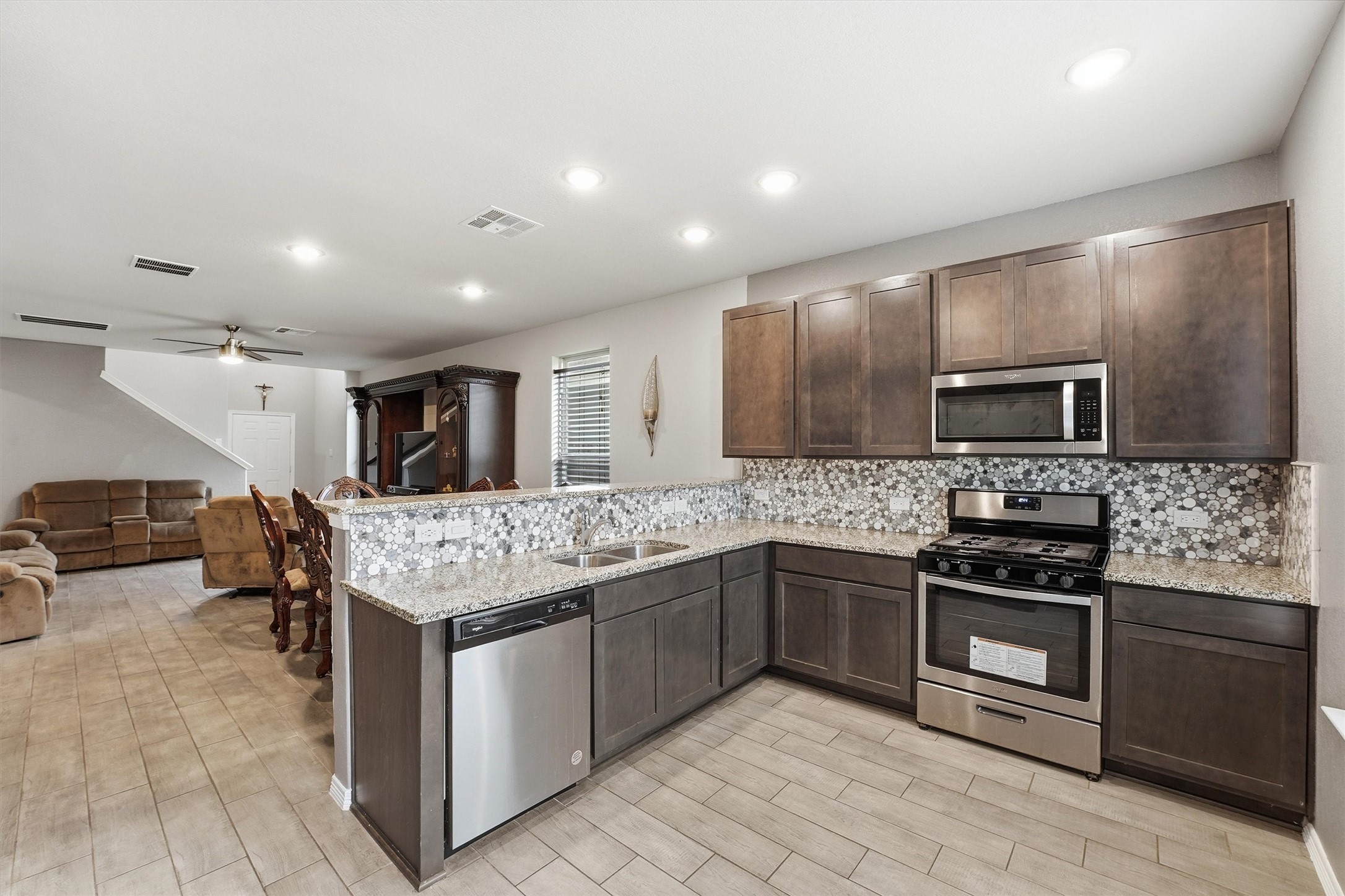 24818 Russet Bluff Trail Houston, TX 77336 - Photo 8 of 23 a kitchen with stainless steel appliances granite countertop a stove top oven a sink and a refrigerator