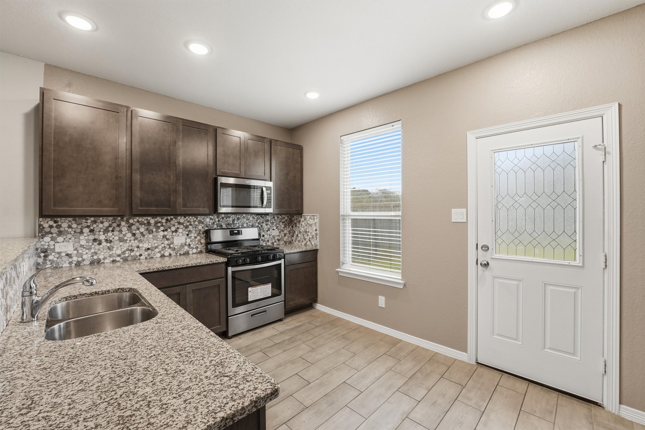 24818 Russet Bluff Trail Houston, TX 77336 - Photo 9 of 23 a kitchen with stainless steel appliances granite countertop a sink stove and refrigerator