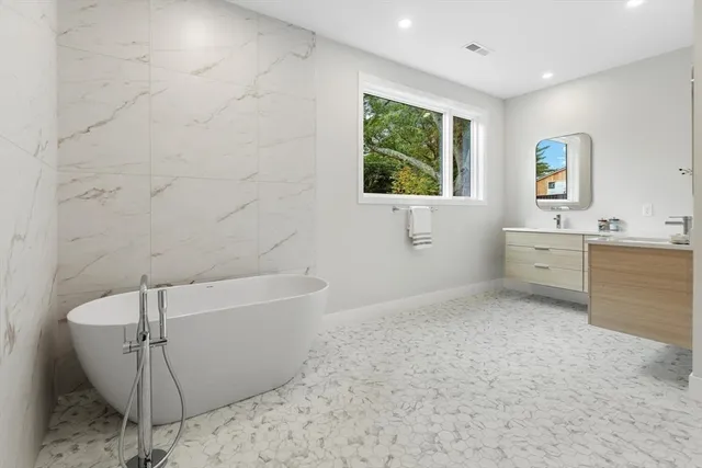 a bathroom with a bathtub and window